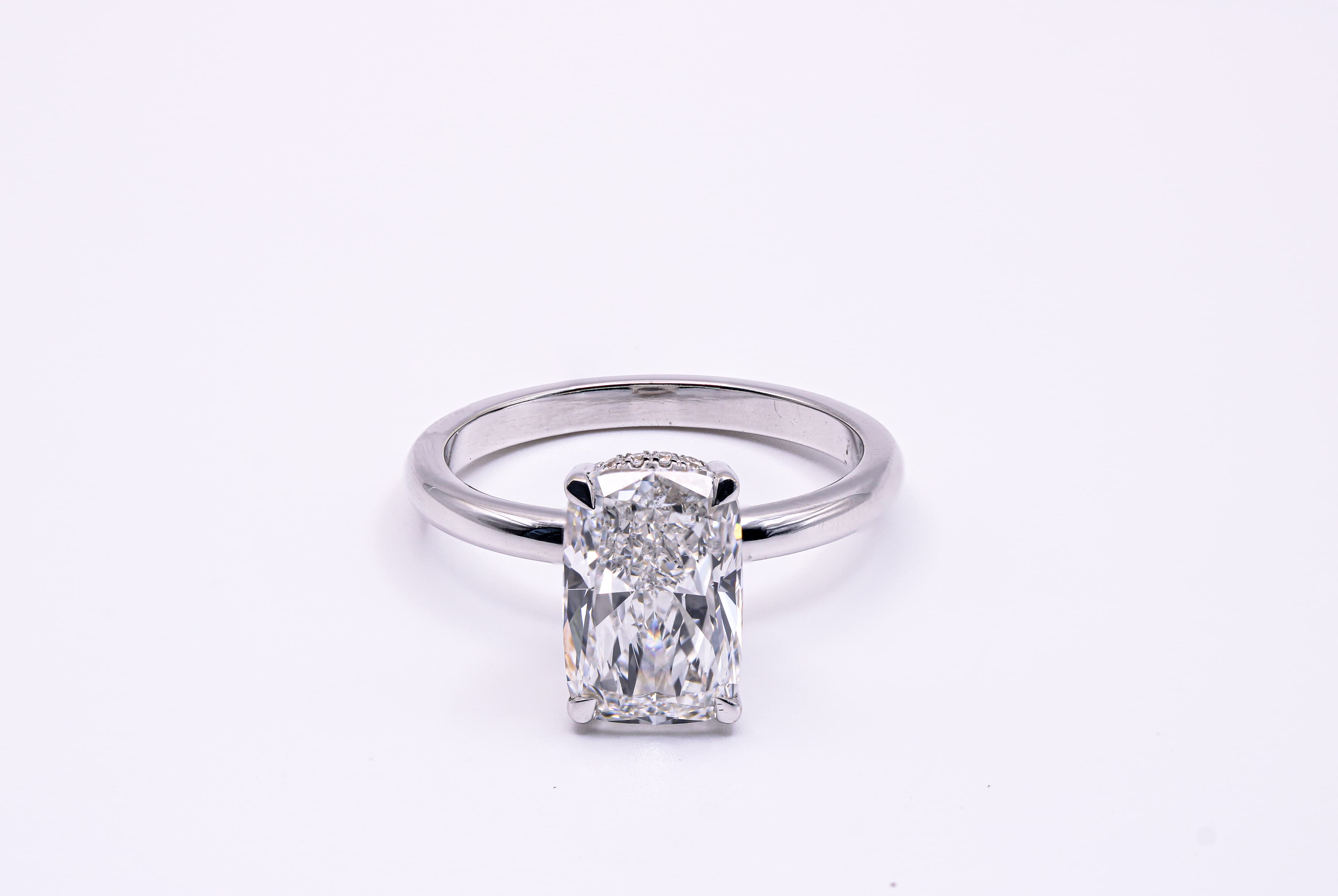 Cushion cut hidden halo engagement ring