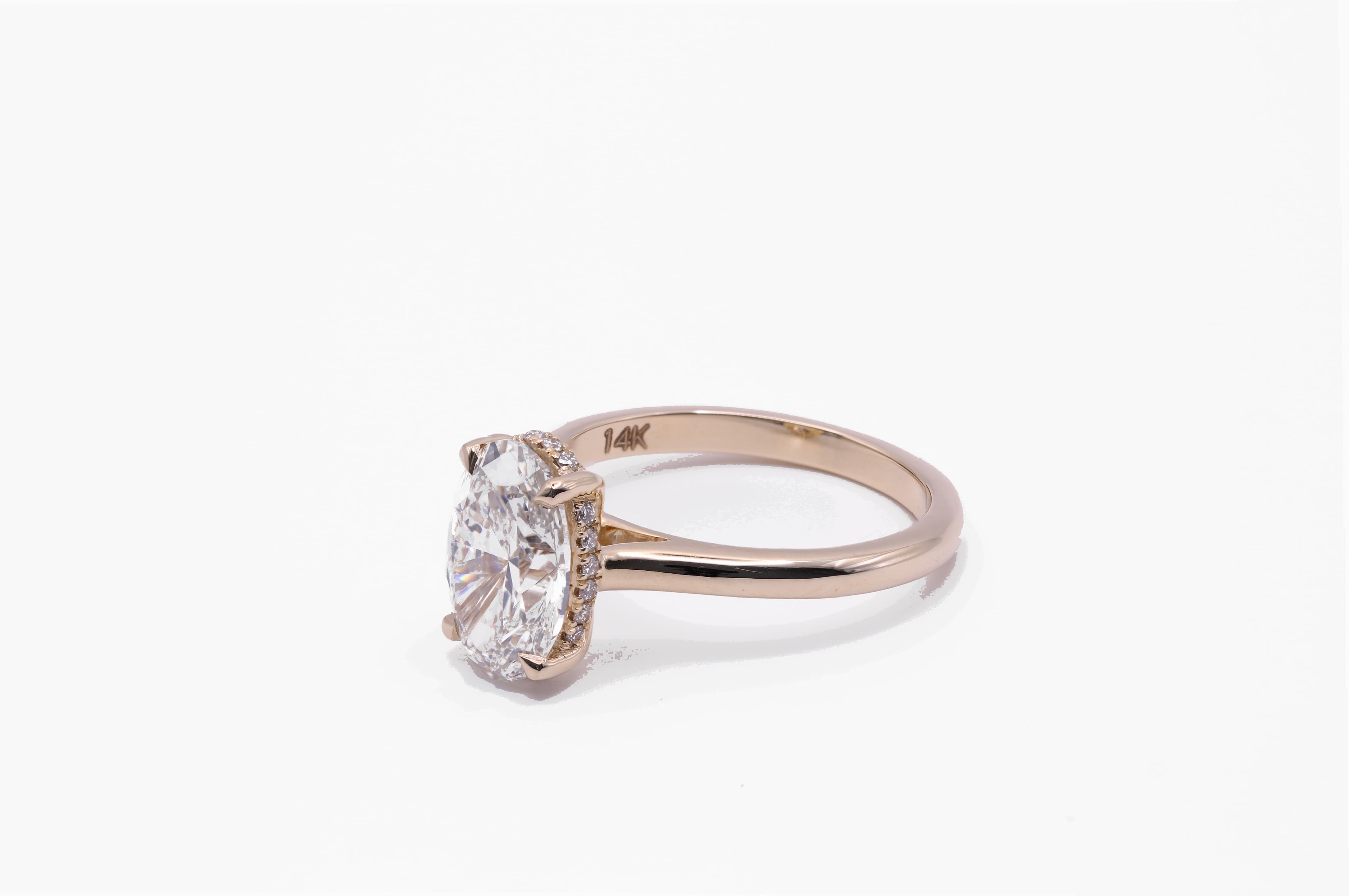 Oval hidden halo engagement ring side view